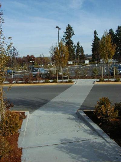 Clearly defined pedestrian connections shall be provided: between public sidewalks and building entrances when buildings are not located directly adjacent to the sidewalk, and between parking lots