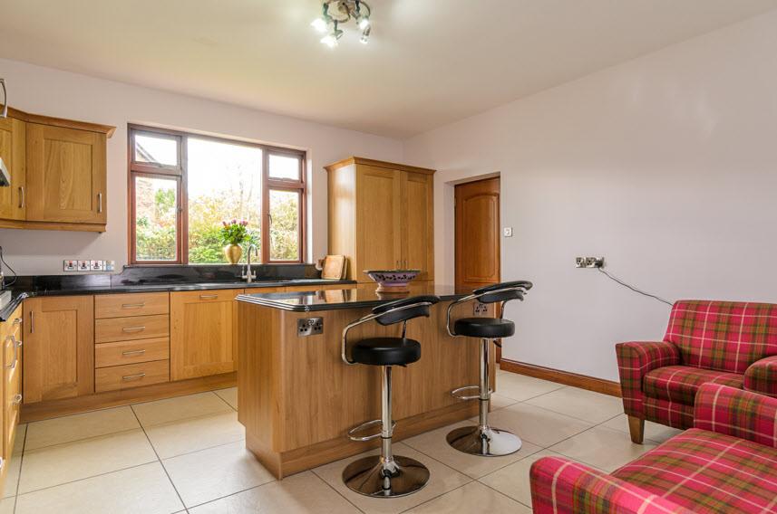 dishwasher, integrated fridge freezer, granite work surfaces, granite drainer and stainless steel sink unit with mixer tap, under unit lighting, glass and stainless steel extractor