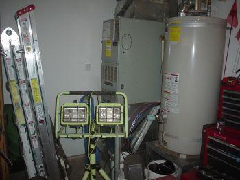 1. Base 2. Combusion deteriorated Water Heater 3. Water Heater Condition Materials: gas Materials: garage operated deteriorated unit evidence of leaking 4.