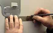 2 Using a level, verify the mounting plate is horizontal and mark the screw