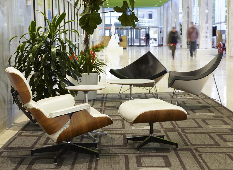 The lobby of one high-rise includes classics like Eames Molded Plywood Chairs, Eames Walnut Stools, and a Noguchi Table.