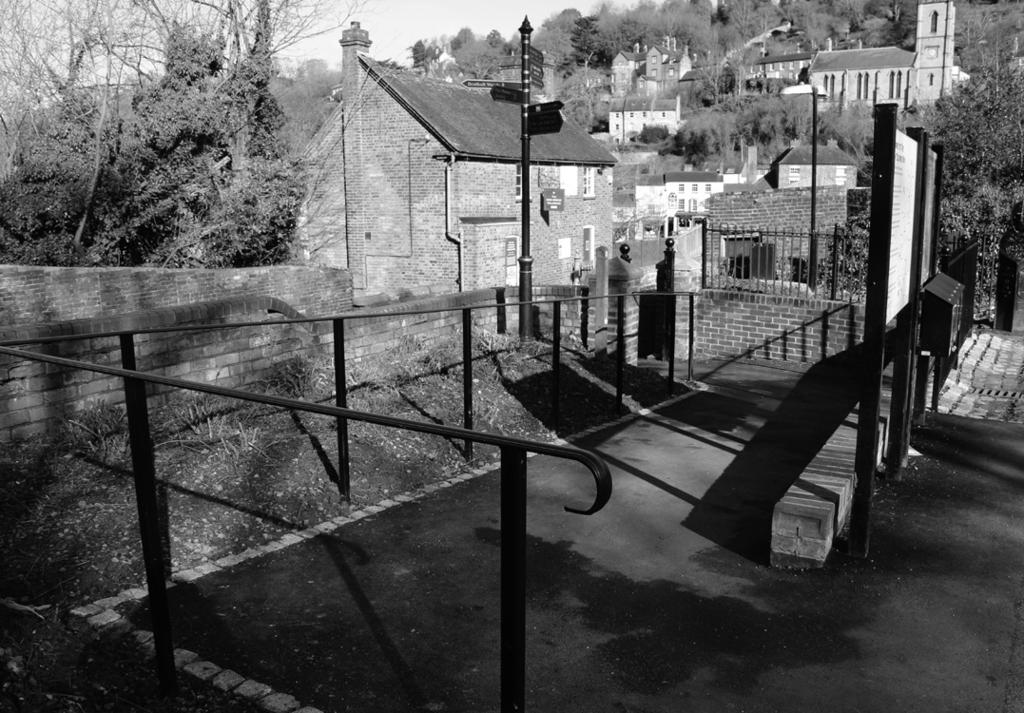 turn on to long unevenly paved ramp and large cobble stones underneath the arches of the Iron Bridge