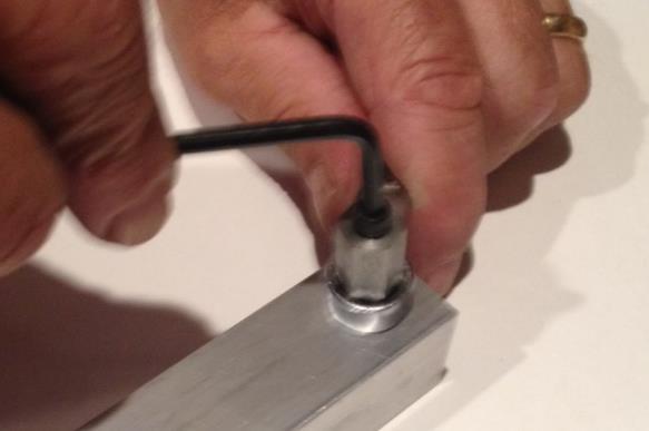Use a wrench to keep the crimp tool and rivet nut from