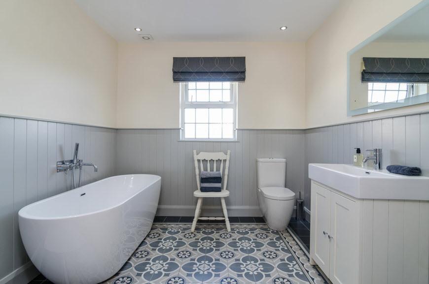 BATHROOM: White suite comprising free standing bath with mixer tap and shower attachment, low