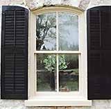 Contrasting black wood louver style shutters