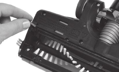 5. Lock the brush roll in place by closing the brush chamber gate and sliding the locking tab in