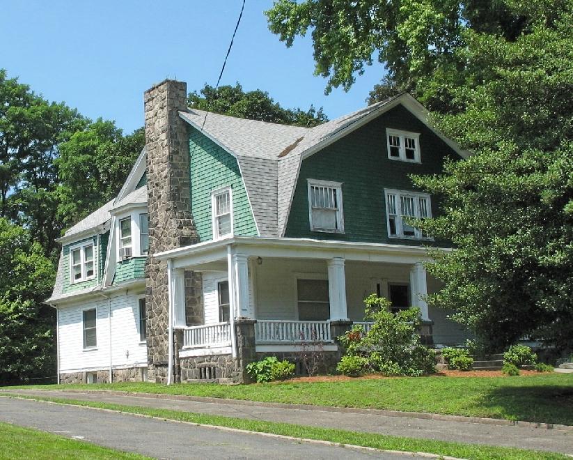 gambrel roof is a dominant visual feature of this Dutch Colonial Revival house.