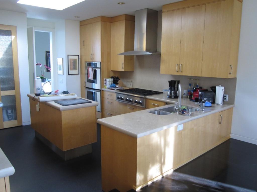 BEFORE (Above): Lack of countertop space, and a small island made access for multiple cooks crowded and uninviting. The colors and mood were uninspiring.