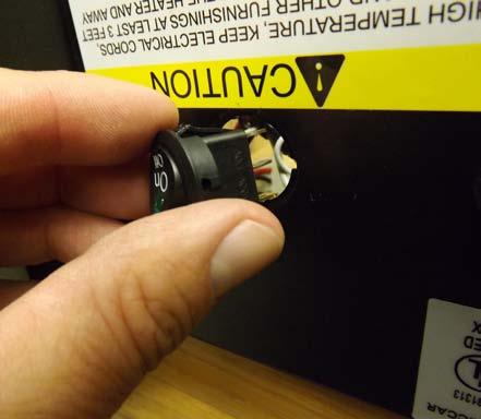 Use a flat screwdriver or pliers to squeeze the switch tabs in while pushing the switch out through the