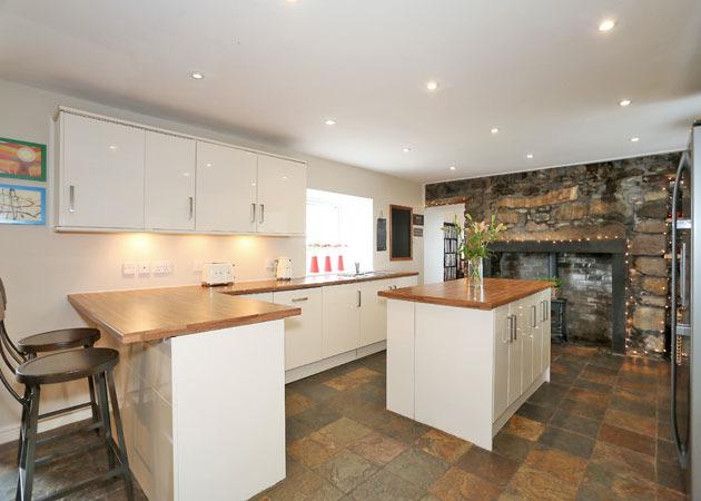 The beautifully appointed Kitchen Area has an extensive range of base and wall units with high gloss finished doors and trim with stainless steel handles and