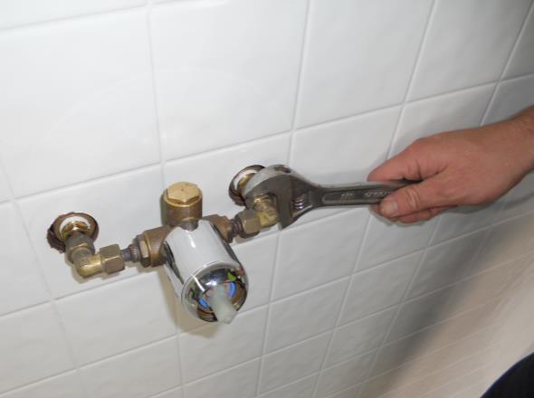 Step 6: Clean the shower wall where the cover will bond to and silicone in the tap holes but not in