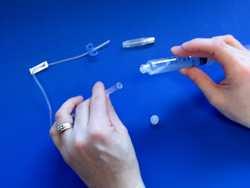 STEP 14 When all of the factor solution has been withdrawn into the syringe, put the needle cover on, using only one hand