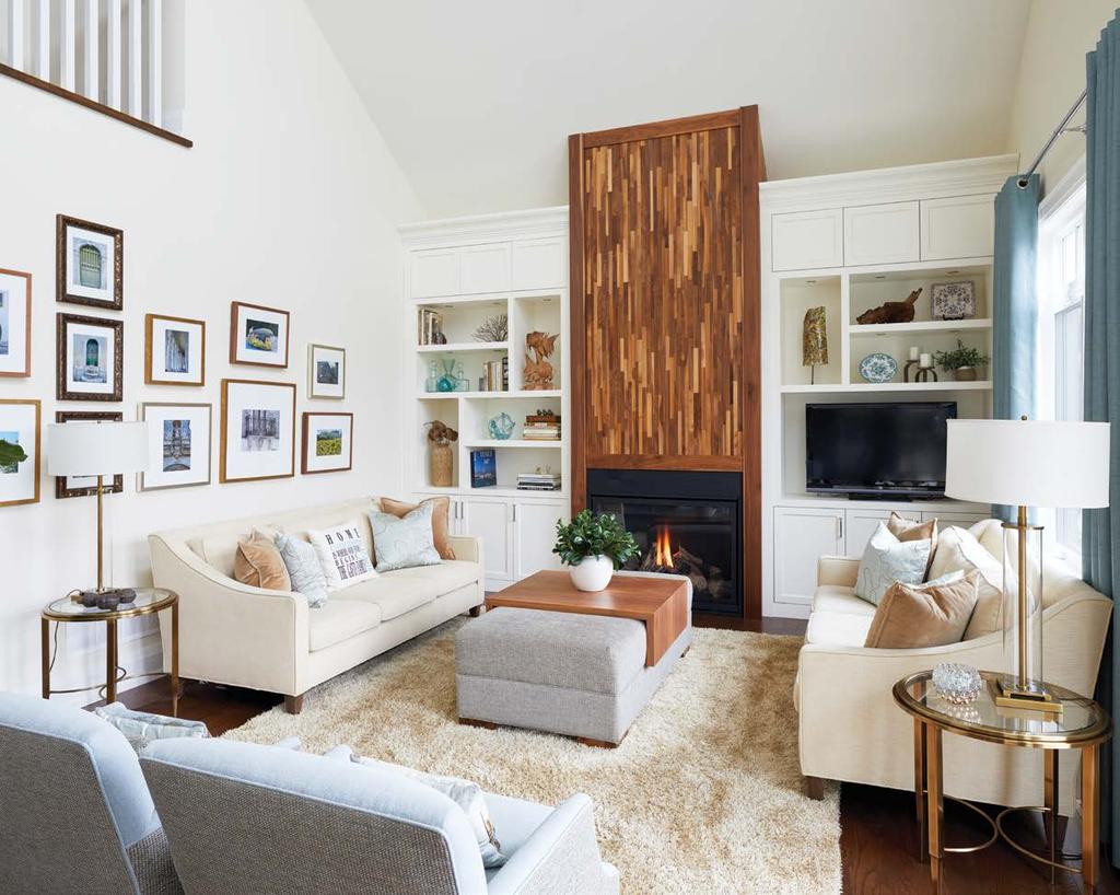 The stacked walnut fireplace surround and crisp, white built-in cabinetry is a focal point in the family room. RIGHT: The kitchen and family room open to the above loft.