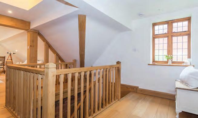 First Floor The fine solid oak staircase leads up to the first floor galleried landing and across from this is the stunning living room with its high vaulted ceiling, balcony and Velux windows.