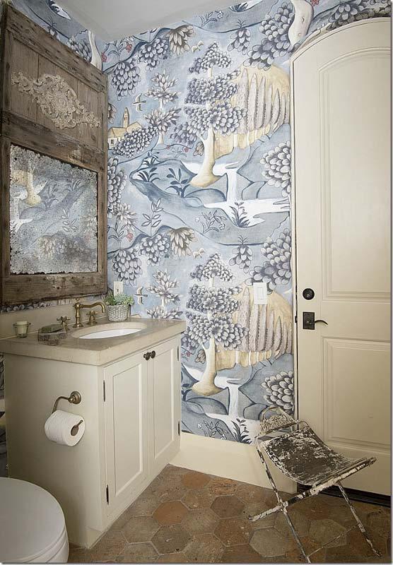 In the pool bath the original terra cotta floors remained. Nicole Zarr put up a new wallpaper and added an antique mirror.