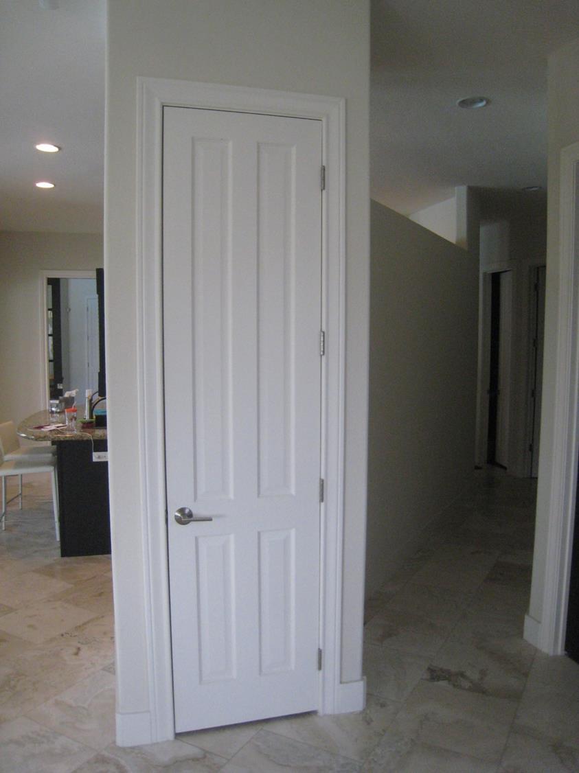 A coat closet and a long dark hallway were the focal point upon entering the home.
