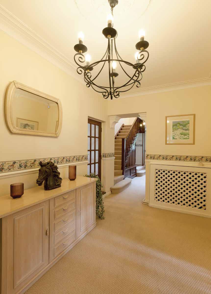 Rose Cottage Entrance Hall With coving to the ceiling, ceiling rose, two central heating radiators with decorative covers, dado rail and stairs rising to the first floor.