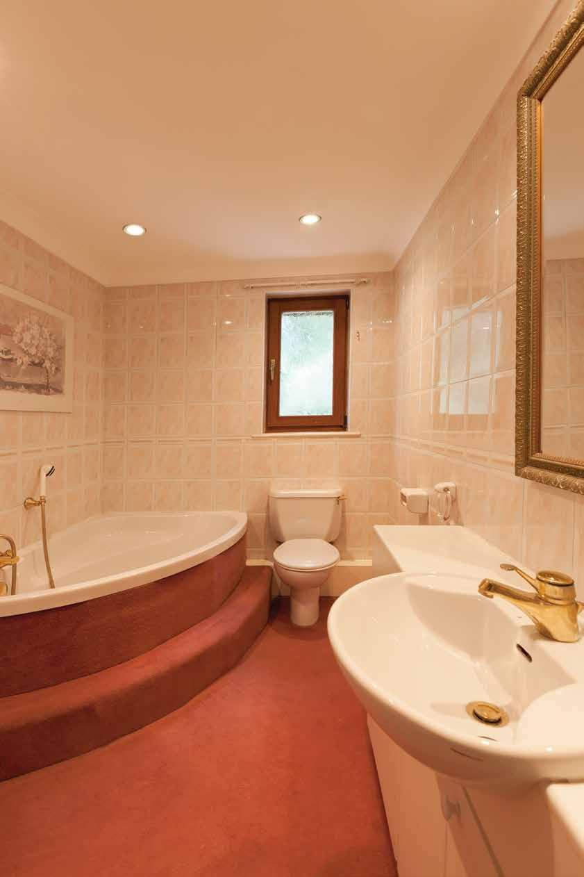 Family Bathroom With a rear facing timber double glazed obscured window, recessed lighting, central heating radiator, fully tiled walls, coving to the ceiling, loft access.
