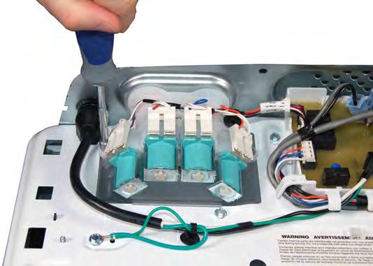 Removing the Water Inlet Valve NOTE: The water inlet valve is replaced as an assembly, which includes all four valves, bracket, and valve assembly harness. 1. Unplug washer or disconnect power. 2.
