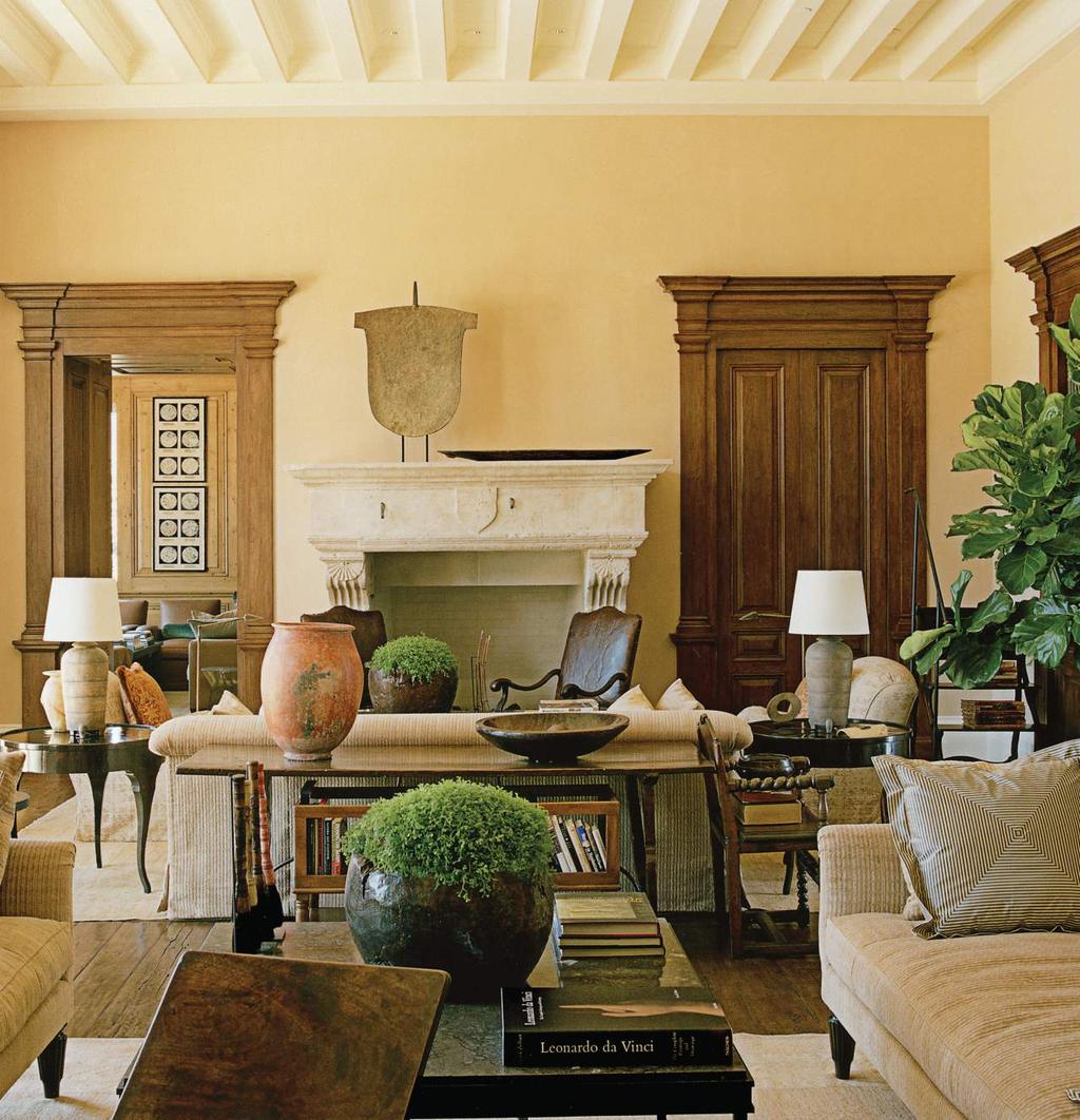 In the living room, rich custom walnut moldings, deliberately designed to harmonize rather than match, frame both the doorway to the