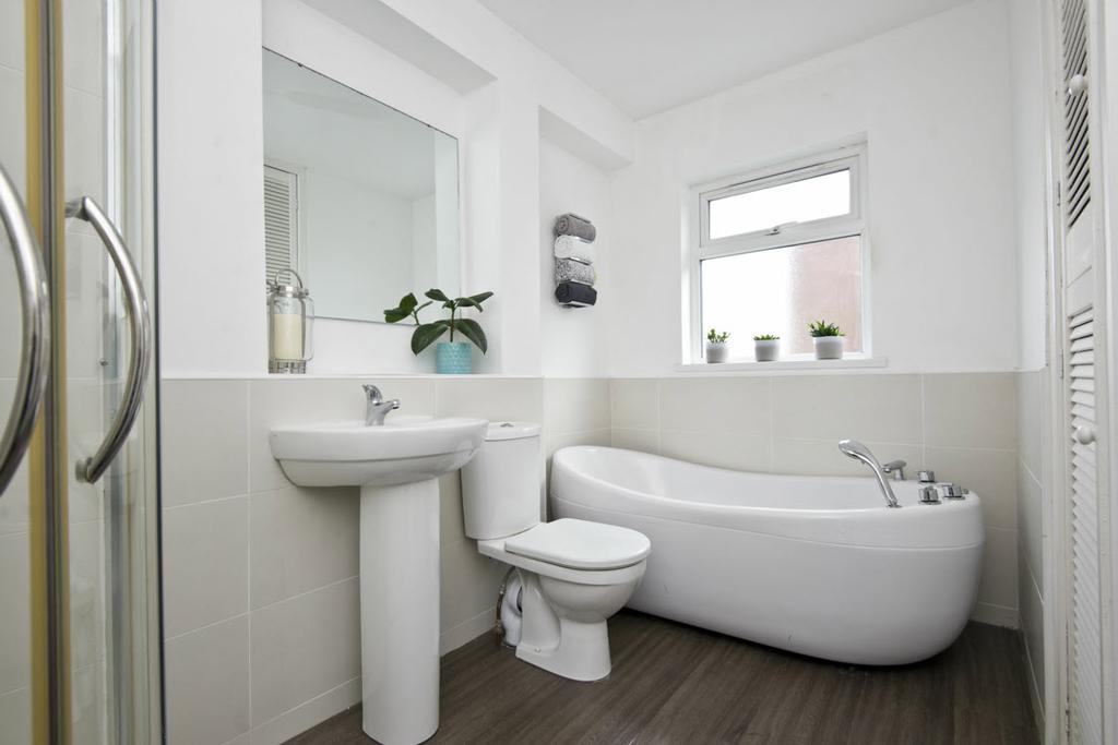 BATHROOM: White suite comprising low flush wc, pedestal wash hand basin with chrome mixer tap, free-standing Jacuzzi
