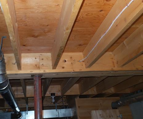 The ceiling joists in the basement are 2 x 10. Water stains on floor joist in basement in area where there are stains on wall in living room.