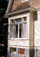 Shallow square bay window with a ribbon of four