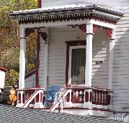 537 5th Avenue Shed roofed partial porch with extended pediment over entrance supported by heavy columns of the Queen