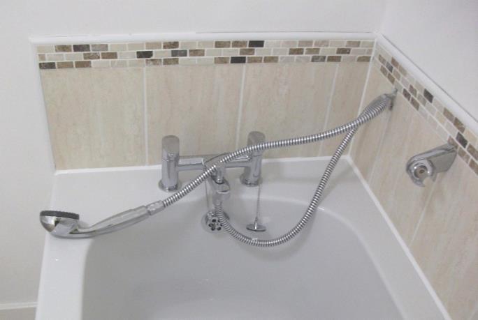 Figure 10: Correctly restrained shower hose Installing a double check valve to the shower hose connection on the bath combination tap or shower valve (Figure 11).