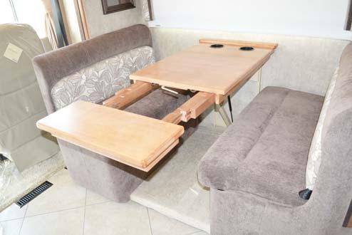 Align table extension pegs with table insert holes and push edge of dinette table in