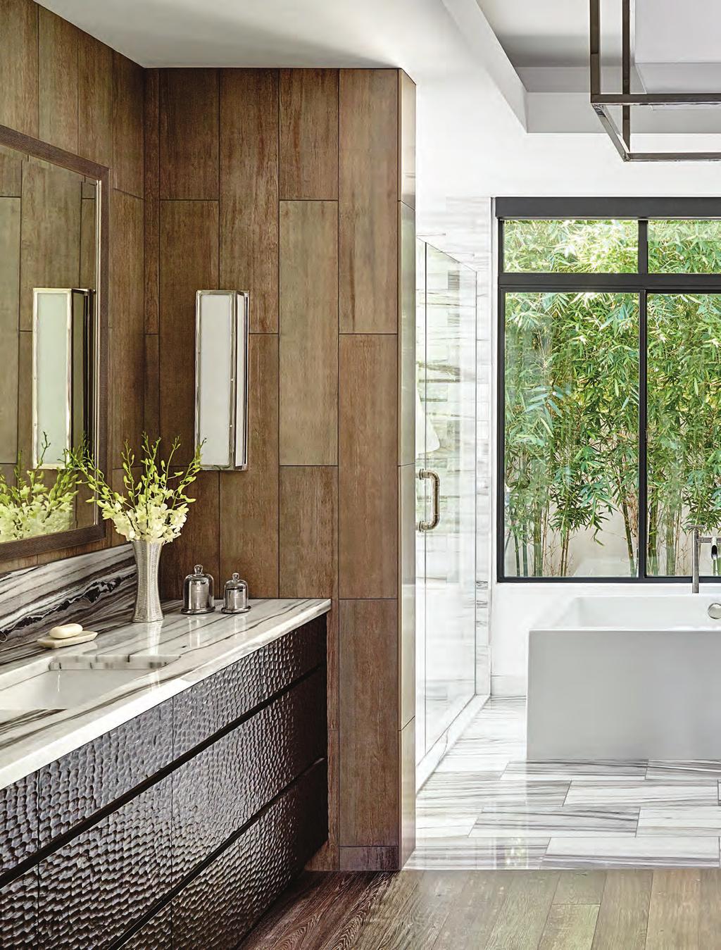 92 Elegant Homes The use of two different floor coverings creates an elegant distinction between the bathing and dressing areas of the T-shape master bath.