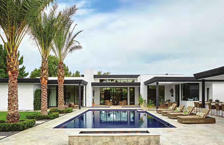 RIGHT: The home s U-shape configuration is accentuated by three connected porches and pools.