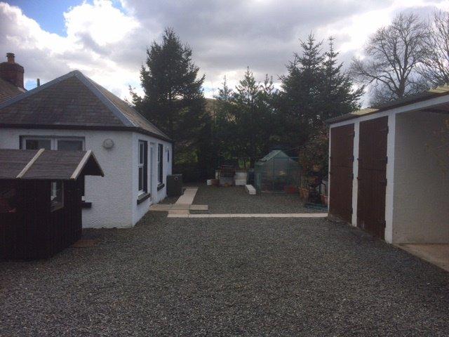 Driveway continues around far side of house to the rear. Rear Garden:- To the rear is a large gravelled area providing further parking.