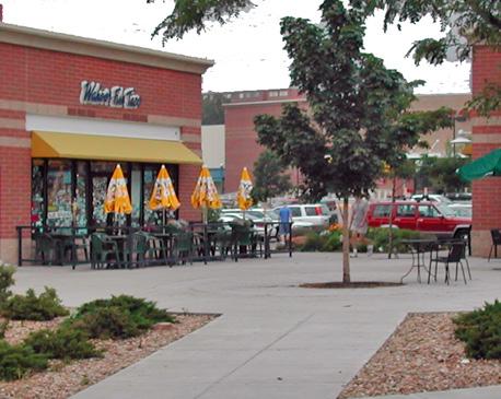 30 Locate an outdoor dining area to accommodate pedestrian traffic along the sidewalk. a. Locate a dining area immediately adjacent to a building front, in an inset or in a side courtyard to maintain a public walkway along the curb side.