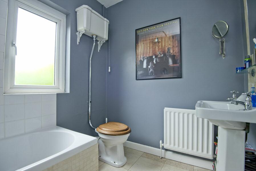 BATHROOM: White suite comprising panelled bath with chrome mixer taps and rain head thermostatic shower unit.