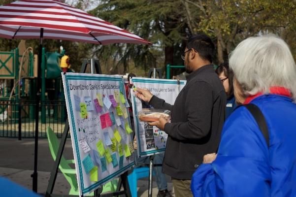Plan: Activated Alleys, Outdoor Dining, Housing, Public Gathering Spaces, and Other. Community members were also encouraged to submit comment cards at the event.