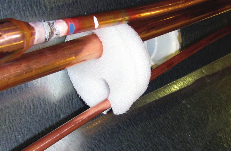 Rear piping penetration is located at the rear-right area, consisting of a pre-cut access punch-out, exposing the foam material that must be penetrated prior to pipe joining (Fig. 10).