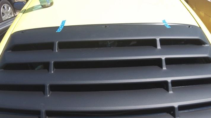 3. Temporarily place the louvers on the rear window and take note where the mounting holes line up on your window.