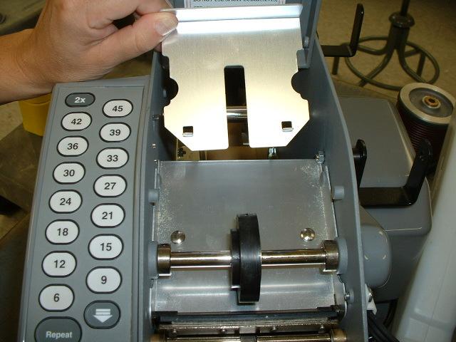 PREPARING THE MACHINE FOR OPERATION 1. If the upper tape plate has been dislodged in shipping, it must be replaced.