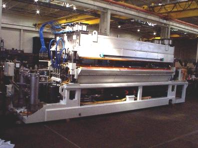Squeegee rolls at the output end of the unit provide desired film thickness and seal the exit end of the wash chamber.