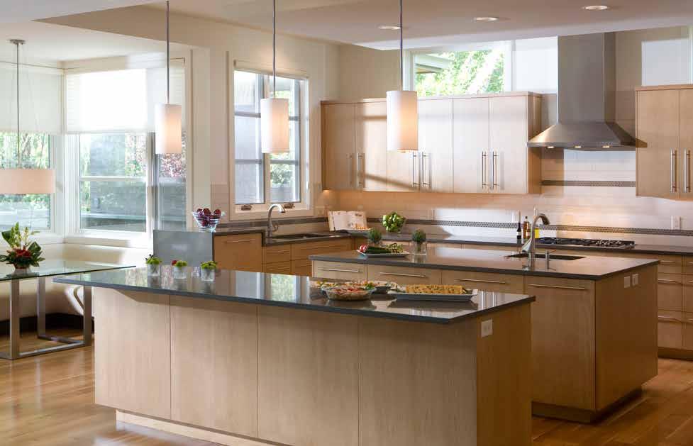 ABOVE: Maple cabinets and layers of light make the kitchen functional and versatile. During the day, transom windows along the cabinet wall flood the space with natural light.