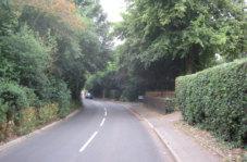 The spacing of the houses, open front gardens and hedges and trees helps to provide a soft edge and add to the rural character of the lane (figure 21), although recent garage blocks, hard