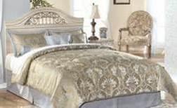 a dark champagne color finish Ornate inserts in the mirror and bed crown Traditional base rail cut out details Beds available: King