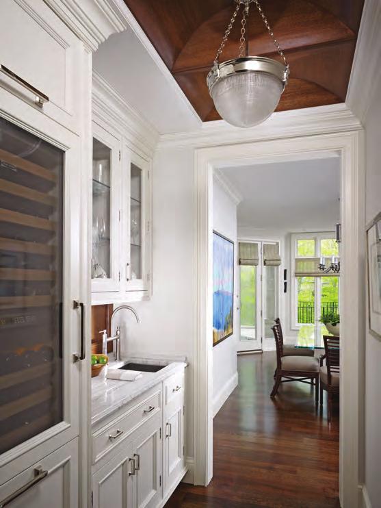 To keep the room feeling bright but also cozy, we combined richly stained woods with creamy white cabinets and light countertops.