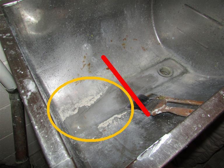 causing a high spot in the middle of the sink. This "ridge" prevents water from completely draining.