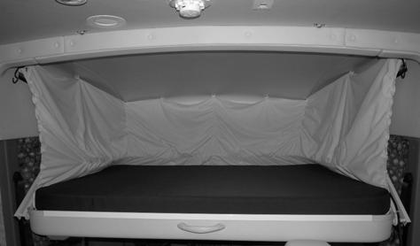 Move both the driver and passenger cab seats forward and recline completely to allow clearance for the bunk to be lowered.