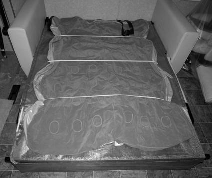 Unfold the air mattress so it is covering the sofa bed. NOTE: The air mattress is plugged into an AC power outlet behind the sofa.