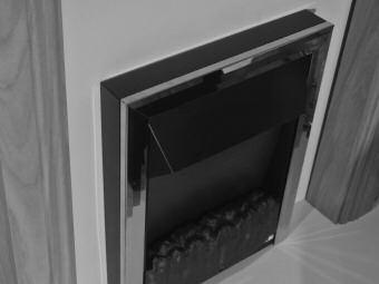 fitted to the fire. You will be able to use either the sticky double sided neoprene strips, or, secure the fire to the wall using the key hole slots on the rear of the spacer frame with screws.