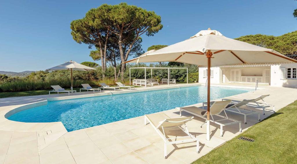 Positioned just away from the villa, the large swimming pool and stone terraced surround has a pretty pool house with shuttered windows, which has a shower and changing room on one side and a