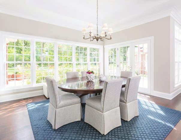 Both the dining room and the living room opposite sport soft wool rugs, costumed designed and colored by Millett in soft hues echoing the beachy, misty, airy feel.